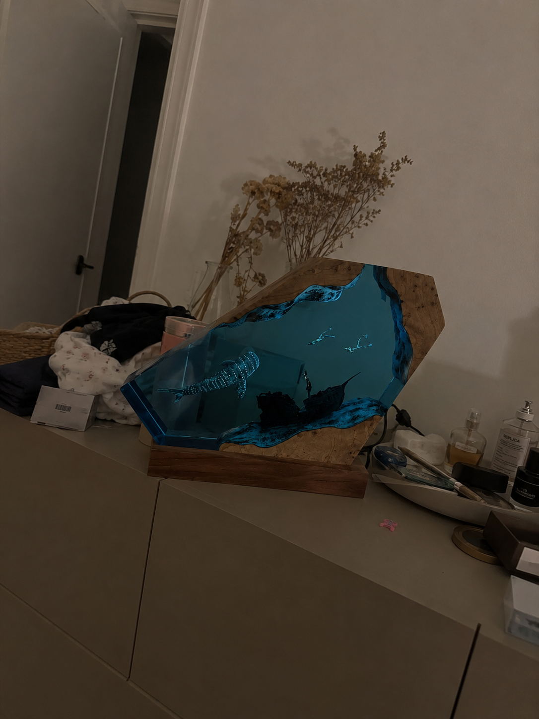 Ocean resin artwork styled on a bookshelf